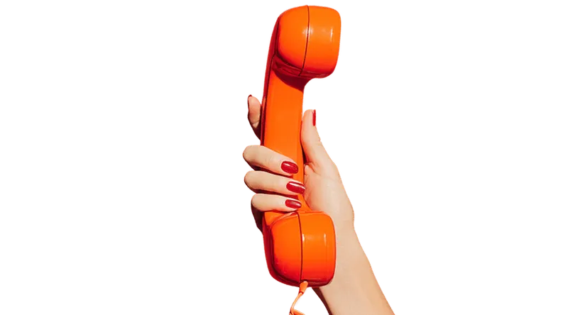 Hand holding an orange telephone handset